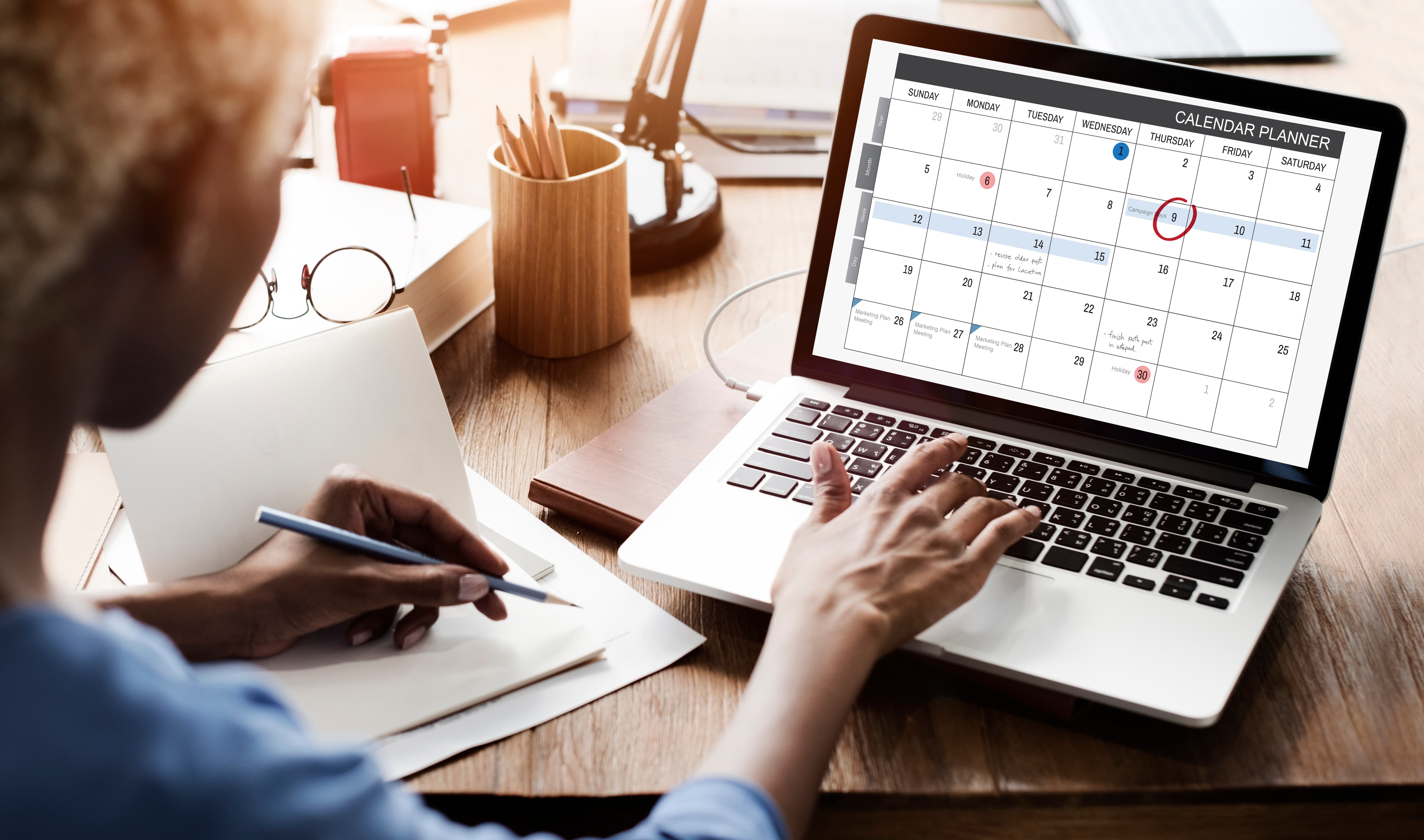 A person checking their calendar on a laptop