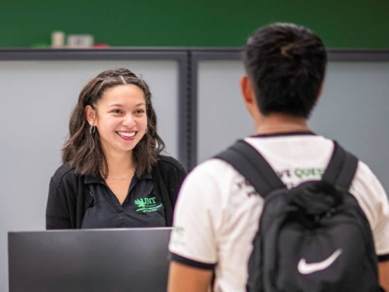 A student being helped at a UNT service counter.