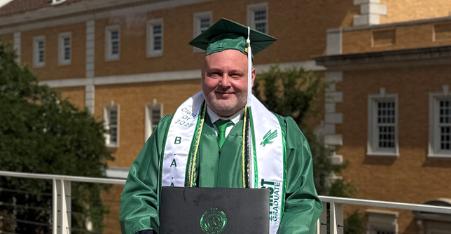 John with a UNT graduation cap and gown