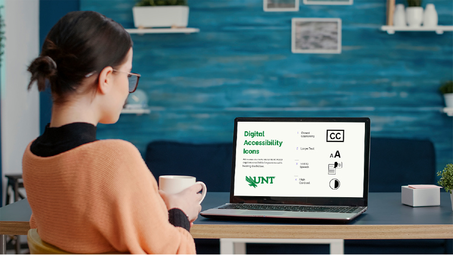 Female learner sits holding coffee mug in front of a laptop
